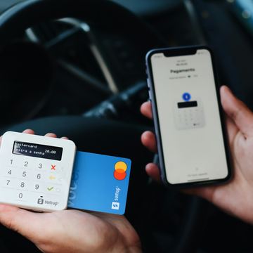 Bàn tay cầm điện thoại và thẻ để thực hiện thanh toán số